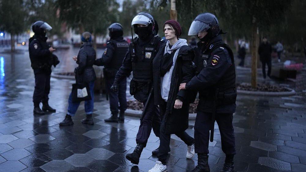 Police officers detain a demonstrator during a protest against a partial mobilization in Moscow, Russia, Saturday, Sept. 24, 2022. (AP Photo)