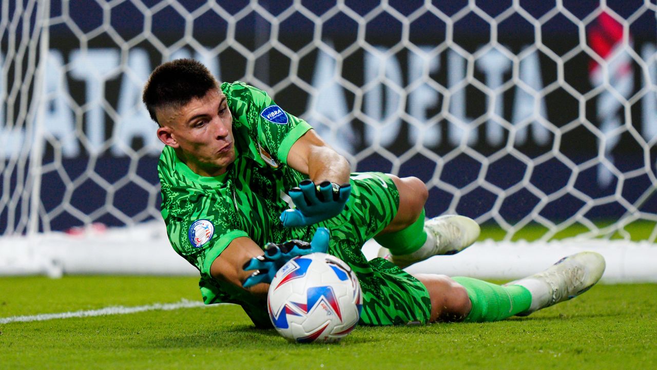 Uruguay's goalkeeper Sergio Rochet stops a shot by Canada's Ismael Kone during a penalty shootout at the Copa America third place soccer match in Charlotte, N.C., Saturday, July 13, 2024. (AP Photo/Jacob Kupferman)