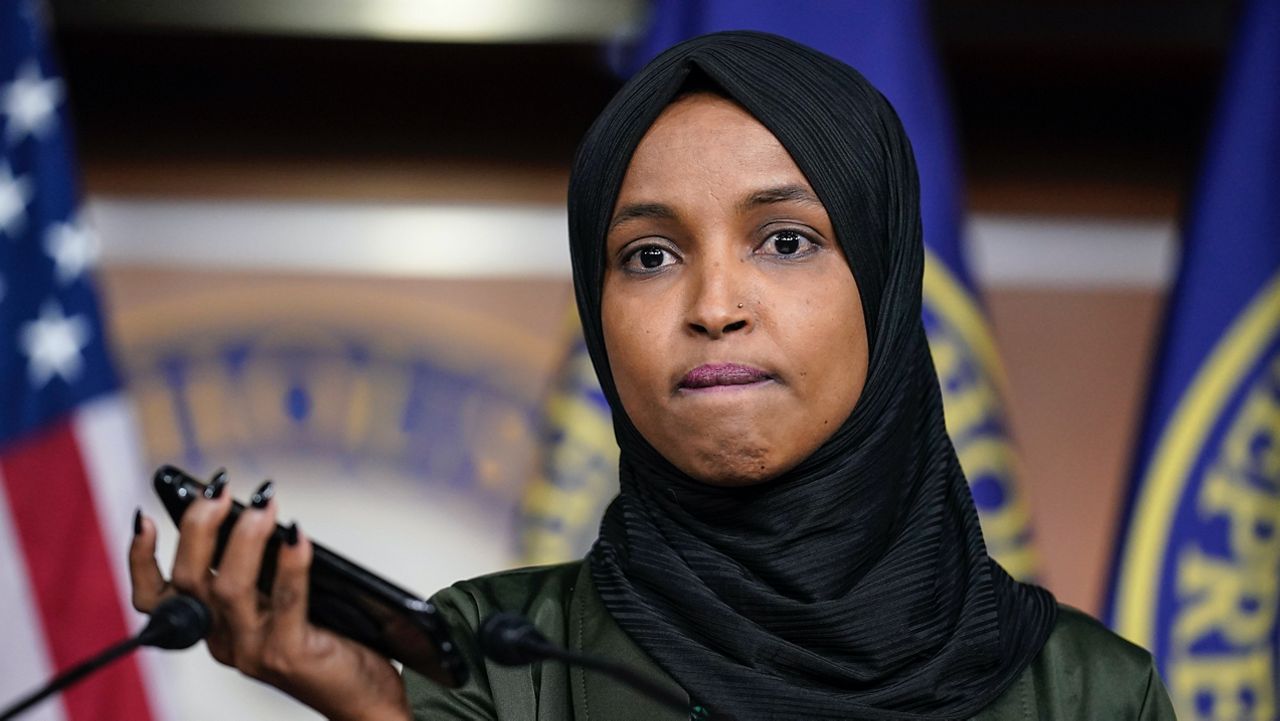 Rep. Ilhan Omar, D-Minn., plays a recording of a death threat left on her voicemail in the wake of anti-Islamic comments made last week by Rep. Lauren Boebert, R-Colo., who likened Omar to a bomb-carrying terrorist, during a news conference at the Capitol in Washington, Tuesday, Nov. 30, 2021. (AP Photo/J. Scott Applewhite)