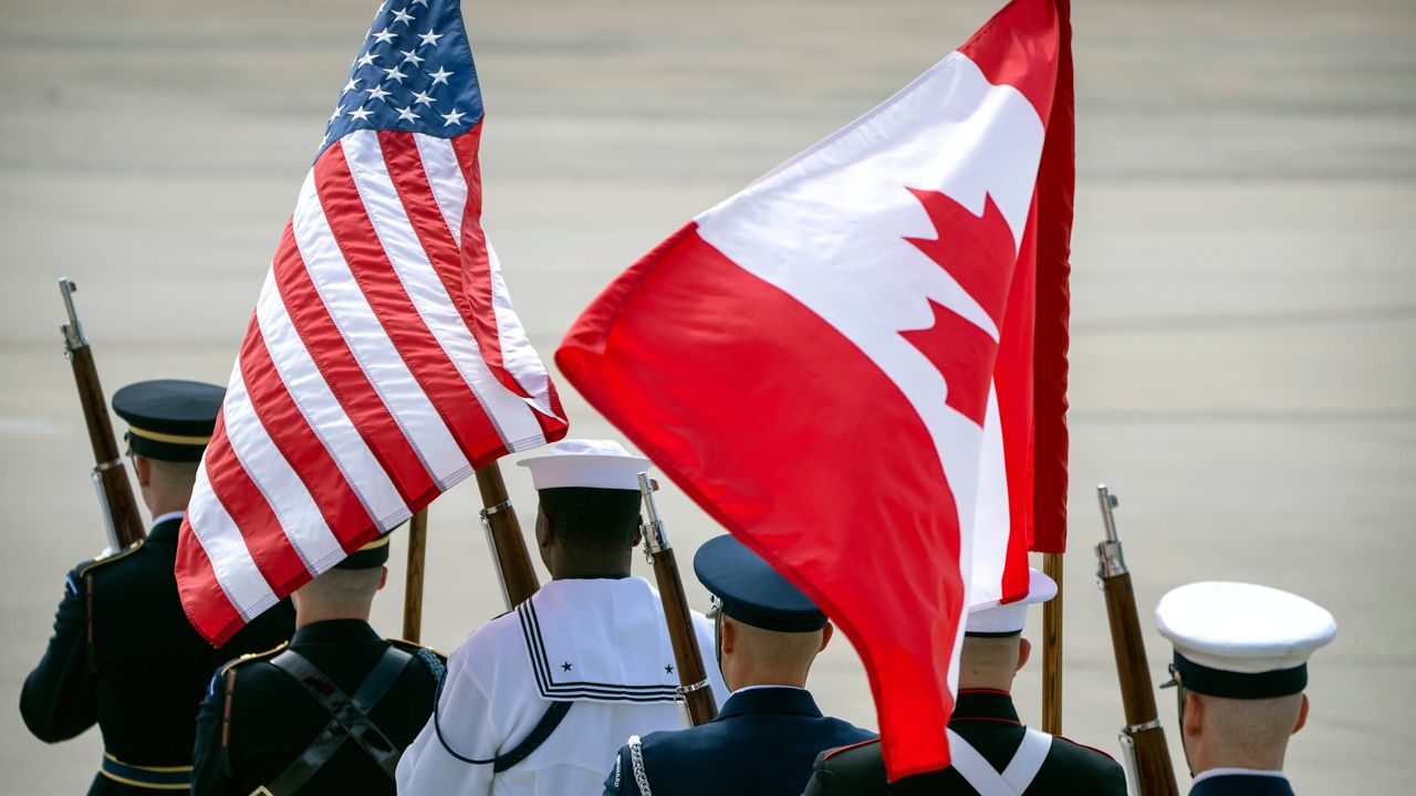 An honor guard marches in formation with U.S. and Canadian flags before the arrival of Canadian Prime Minister Justin Trudeau Monday, July 8, 2024, at Andrews Air Force Base, Md., to attend the NATO summit in Washington. (AP Photo/Mark Schiefelbein, File)