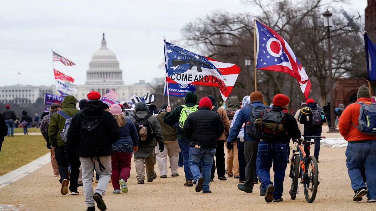 A crowd of Trump supporters march toward the U.S. capital building