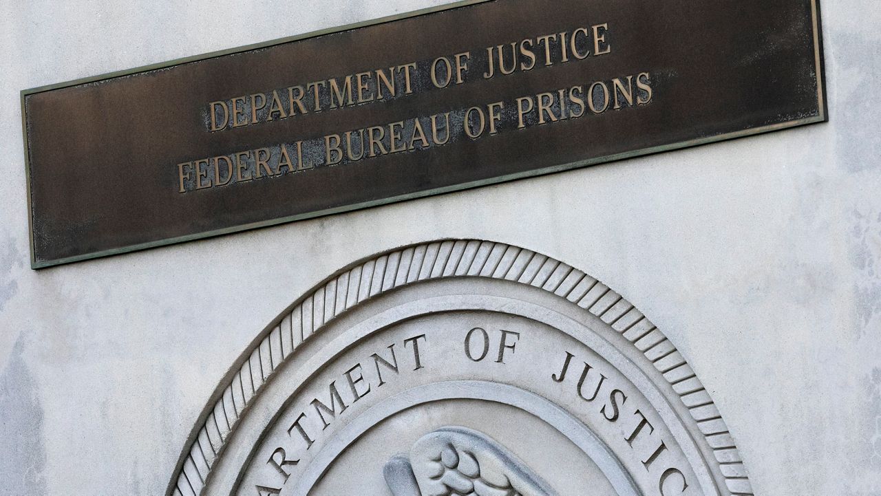 Plaque reads "Department of Justice, Federal Bureau of Prisons"