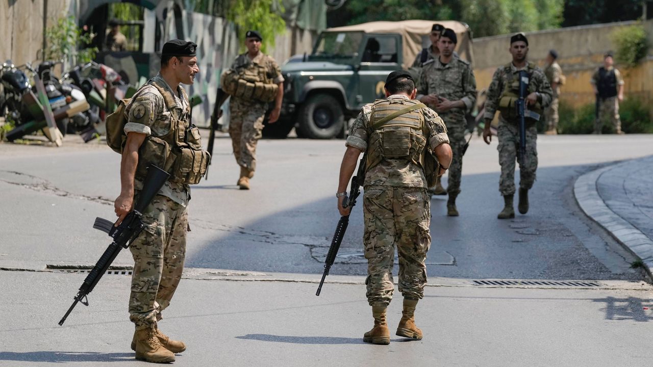 Lebanese security stand guard on a road that leads to the U.S. Embassy in Aukar, a northern suburb of Beirut, Lebanon, Wednesday, June 5, 2024. (AP Photo/Bilal Hussein)