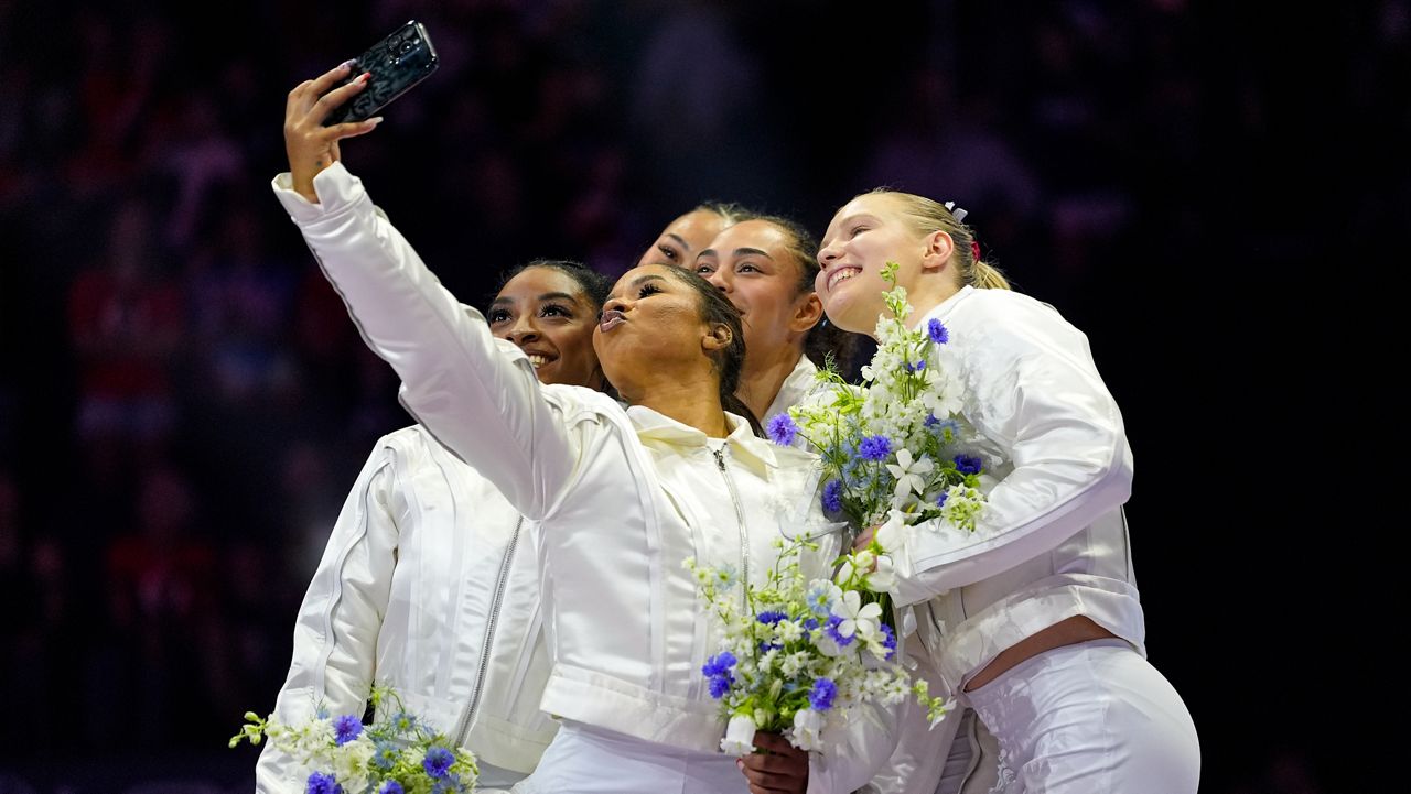 Jordan Chiles takes a selfie with the team after the women were named to the 2024 Olympic team at the United States Gymnastics Olympic Trials on Sunday, June 30, 2024, in Minneapolis. (AP Photo/Abbie Parr)