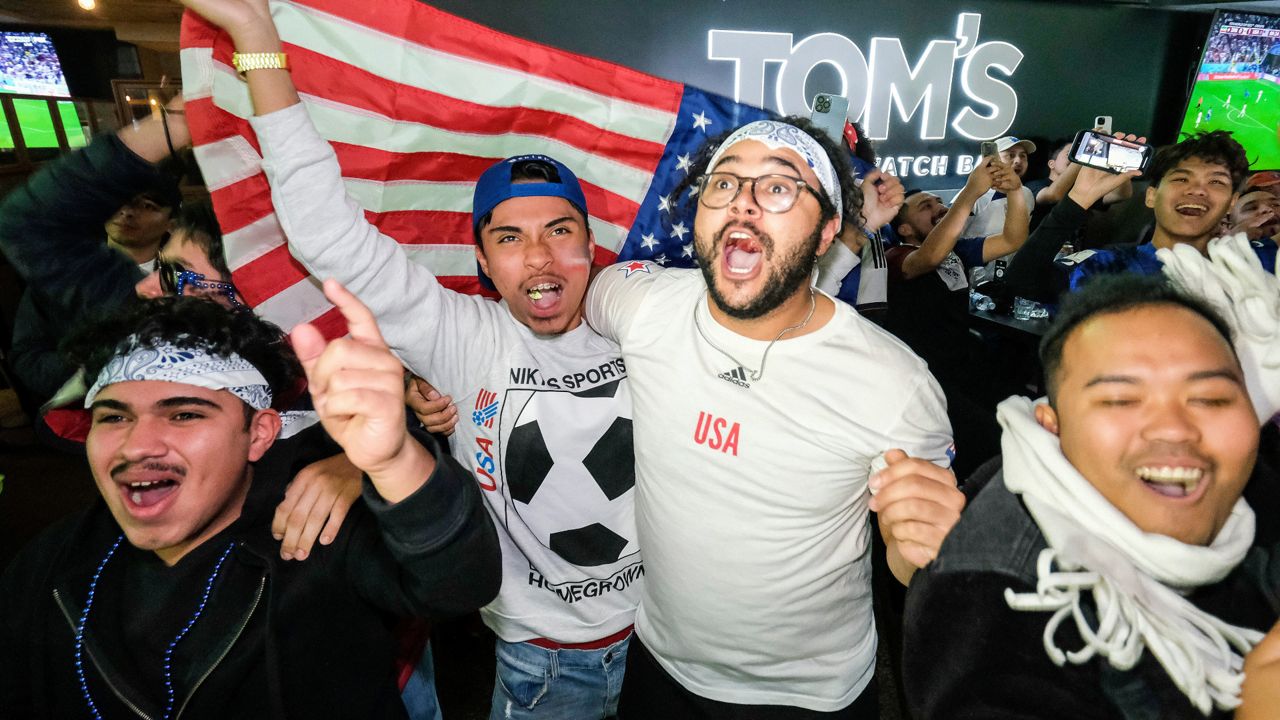 U.S. soccer fans celebrate at a watch party after their team defeated Iran in the Qatar World Cup group B soccer match, in Los Angeles, Tuesday, Nov. 29, 2022. (AP Photo/Ringo H.W. Chiu)