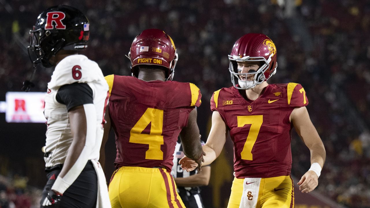 Southern California quarterback Miller Moss (7) celebrates a touchdown by running back Woody Marks (4) during the first half of an NCAA college football game against Rutgers, Friday, Oct. 25, 2024, in Los Angeles. (AP Photo/Kyusung Gong)