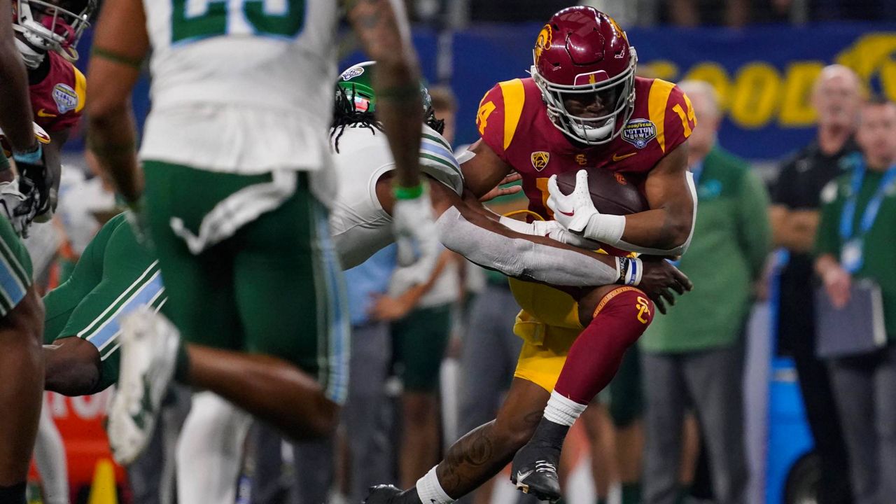 Southern California running back Raleek Brown is hit while running with the ball during the first half of the Cotton Bowl NCAA college football game against Tulane on Monday in Arlington, Texas. (AP Photo/Sam Hodde)