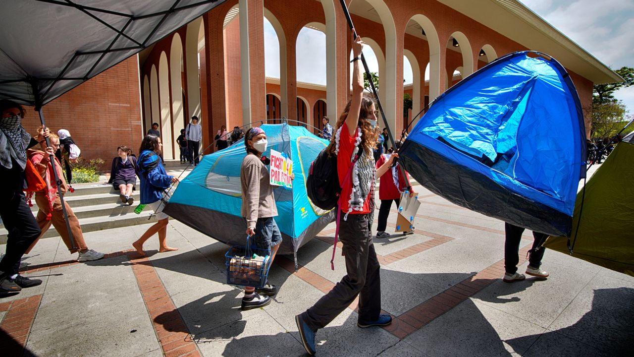 University of Southern California protesters carry a tents around Alumni Park on USC to keep security from removing them during a pro-Palestinian occupation on Wednesday in Los Angeles. (AP Photo/Richard Vogel)