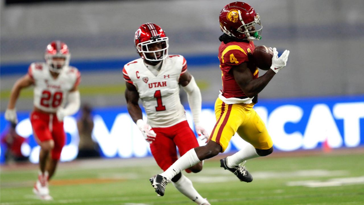 Southern California wide receiver Mario Williams (4) makes a pass reception ahead of Utah cornerback Clark Phillips III (1) during the first half of the Pac-12 Conference championship NCAA college football game Friday in Las Vegas. (AP Photo/Steve Marcus)