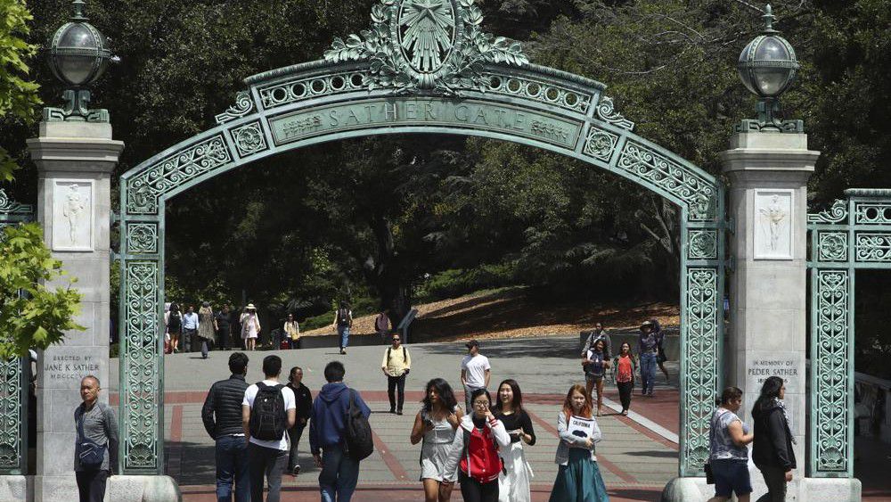 FILE - Students walk past Sather Gate on the University of California at Berkeley campus on May 10, 2018, in Berkeley, Calif. President Joe Biden's student loan forgiveness plan, announced in Aug. 2022, could lift crushing debt burdens from millions of borrowers. However, the tax man may demand a cut of the relief in some states, as some states tax forgiven debt as income. (AP Photo/Ben Margot, File)