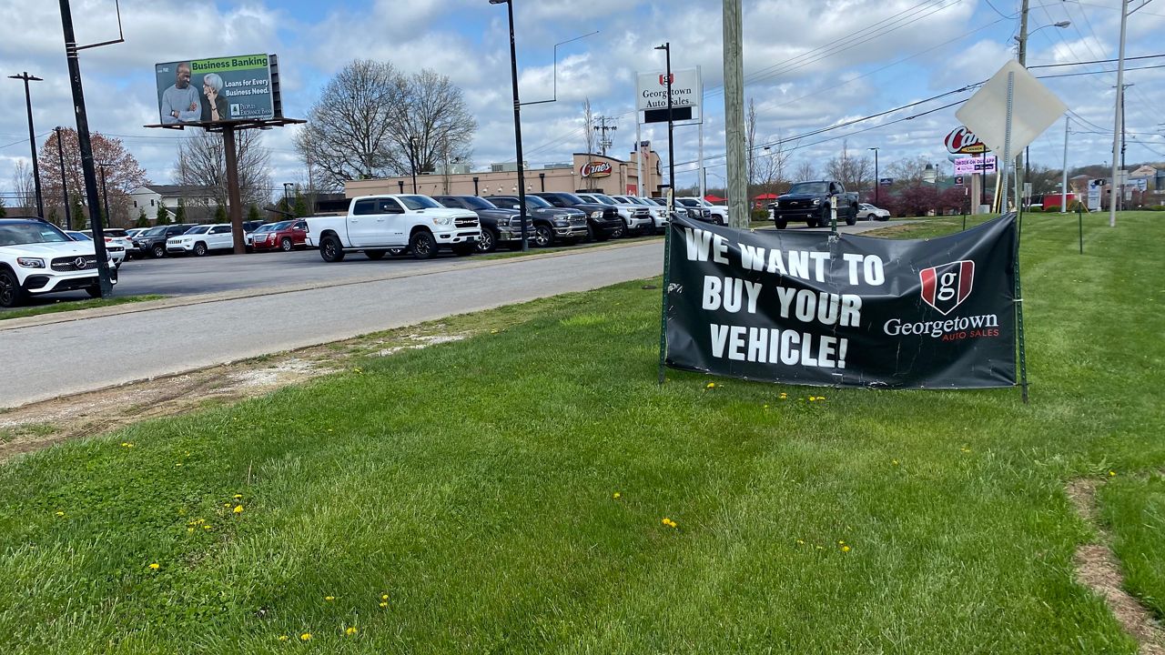 A banner placed by Georgetown Auto Sales is an indicator of the current used car market. (Spectrum News 1/Brandon Roberts)