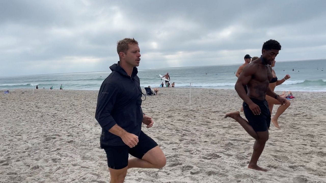 Mo Peacock and team warming up for a sprint workout (Spectrum News 1/Alex Wilkinson)