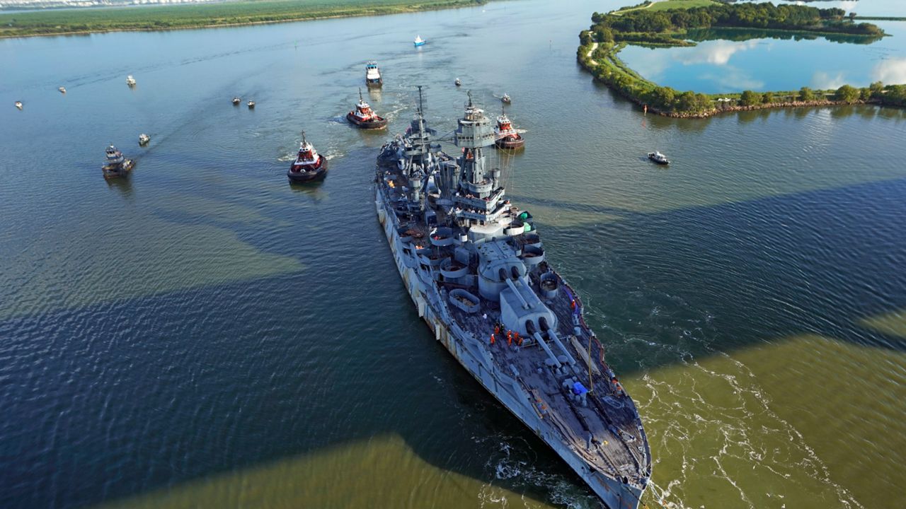 The USS Texas is towed down the Houston Ship Channel Wednesday, Aug. 31, 2022, in Baytown, Texas. The vessel, which was commissioned in 1914 and served in both World War I and World War II, is being towed to a dry dock in Galveston where it will undergo an extensive $35 million repair. (AP Photo/David J. Phillip)