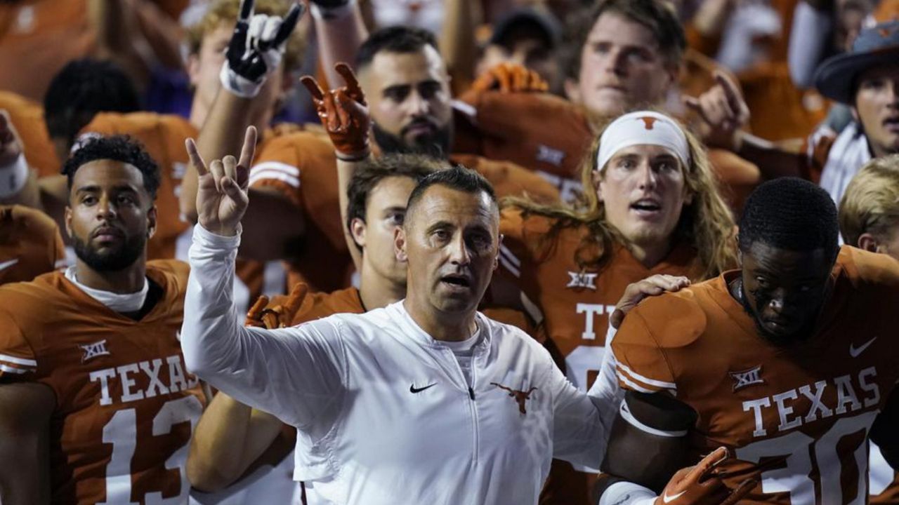Texas head coach Steve Sarkisian, center, stands with players for the school song following an NCAA college football game against UTSA, Saturday, Sept. 17, 2022, in Austin, Texas. (AP Photo/Eric Gay)