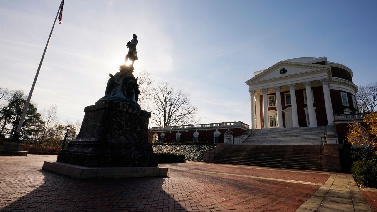 A statue of University of Virginia founder, Thomas Jefferson, stands watch over the Rotunda near the scene of an overnight shooting at the University of Virginia Monday, Nov. 14, 2022, in Charlottesville. Va. (AP Photo/Steve Helber)