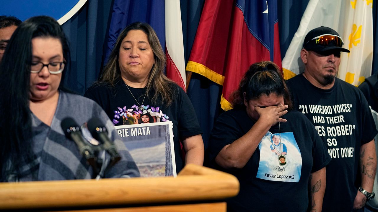 Felicia Martinez, mother of Xavier Lopez who was killed by a gunman at Robb Elementary School in Uvalde, Texas, center tries to hold back tears as she and other surviving family members attend a news conference at the Texas Capitol with Texas State Sen. Roland Gutierrez, in Austin, Texas, Tuesday, Jan. 24, 2023. Gutierrez says he is filing legislation in the wake of Texas' rising gun violence. (AP Photo/Eric Gay)