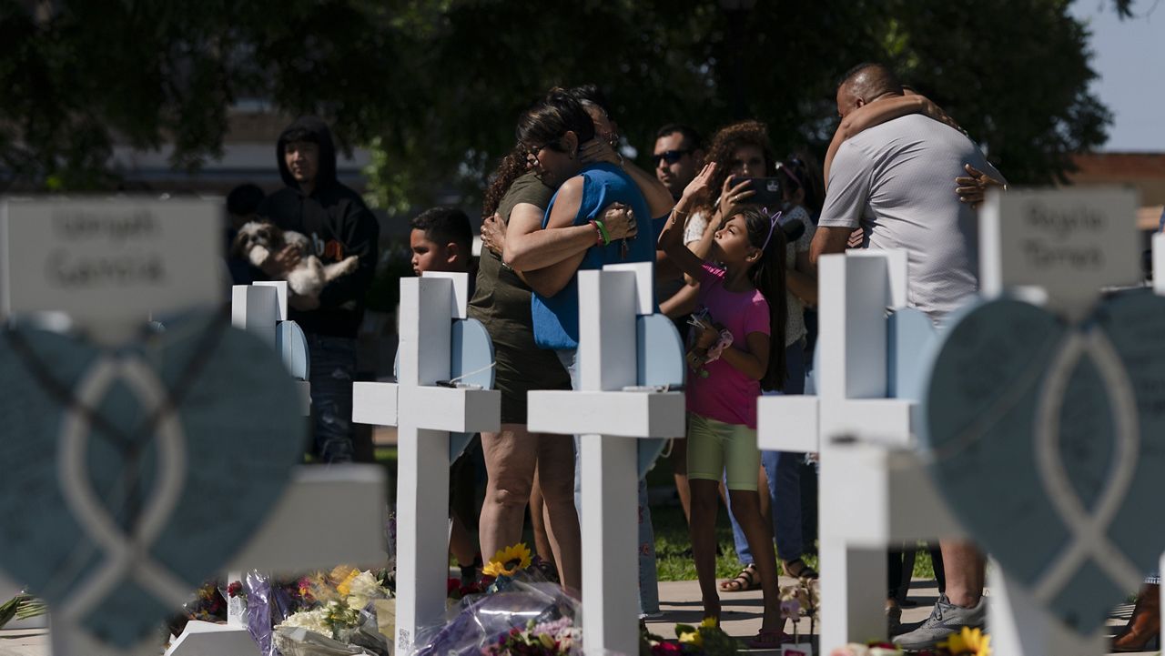 Dora Mendoza, center right, a grandmother of Amerie Jo Garza, one of the victims killed in the school shooting, is comforted by a woman at a memorial site in Uvalde, Texas, Thursday, May 26, 2022. (AP Photo/Jae C. Hong)