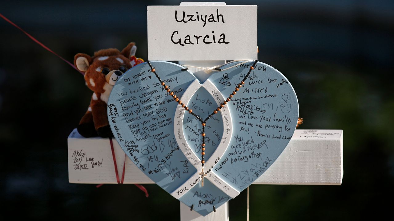 Uziyah Garcia's cross stands at a memorial site for the victims killed in this week's shooting at Robb Elementary School in Uvalde, Texas, Friday, May 27, 2022.