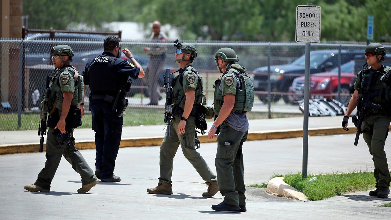 Law enforcement personnel stand outside Robb Elementary School following a shooting, Tuesday, May 24, 2022, in Uvalde, Texas. (AP Photo/Dario Lopez-Mills)