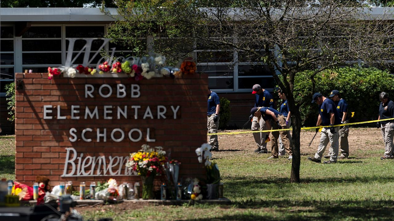 Officers are behind crime scene tape at Robb Elementary School, where 19 students and 2 teachers were killed by an 18-year-old gunman. (AP)