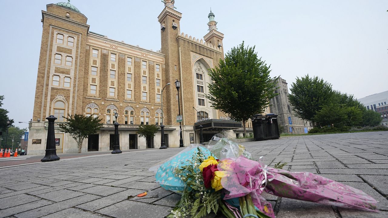 Flowers are placed in front of the Altria Theater, which was the site of a mass shooting after a graduation ceremony Wednesday in Richmond, Va. (AP Photo/Steve Helber)