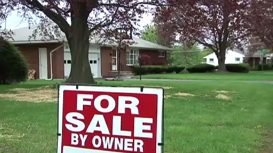 A "For Sale By Owner" sign sits outside of a home. (Spectrum News file image)
