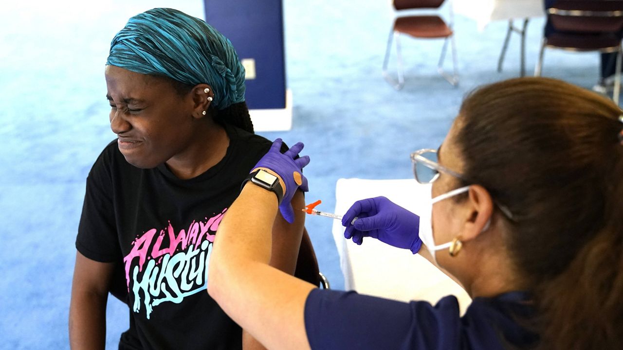 Student Rose Jean-Mary, 19, receives a shot of the Pfizer-BioNTech COVID-19 vaccine at St. Thomas University in Miami on Aug. 20. (AP Photo/Lynne Sladky)