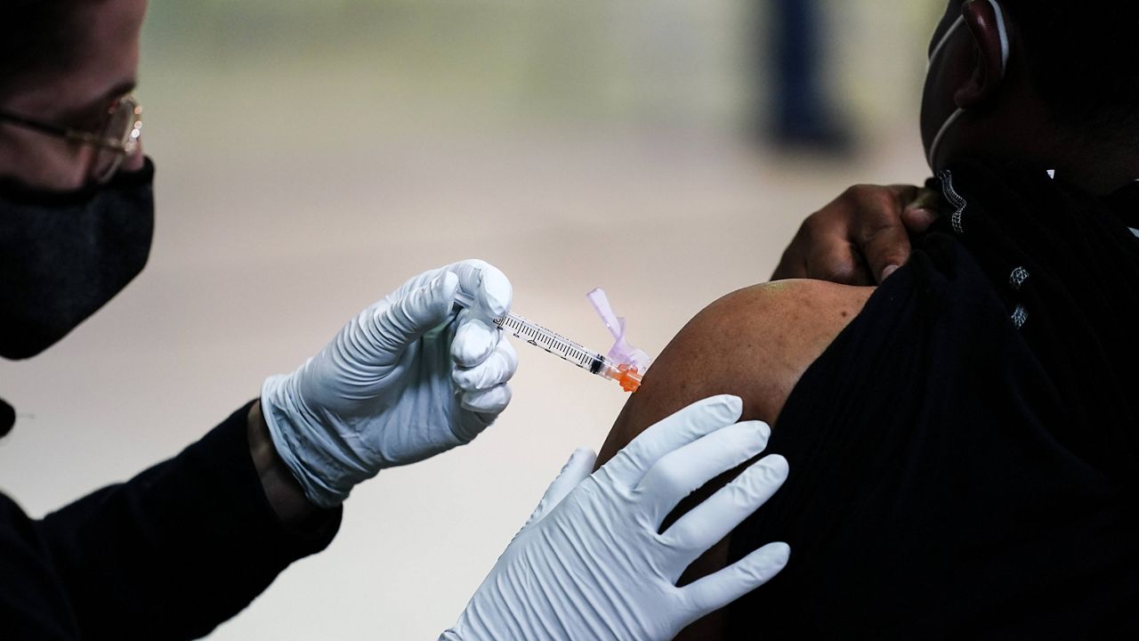 A member of the Philadelphia Fire Department administers the Johnson & Johnson COVID-19 vaccine on March 26. (AP Photo/Matt Rourke, File)