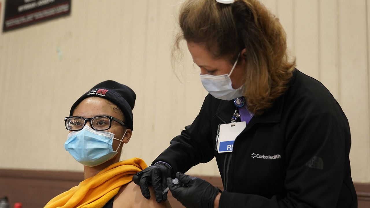 Isis Gardner receives a dose of the Pfizer COVID-19 vaccine in Wilmington, Calif., on Tuesday. (AP Photo/Marcio Jose Sanchez, File)