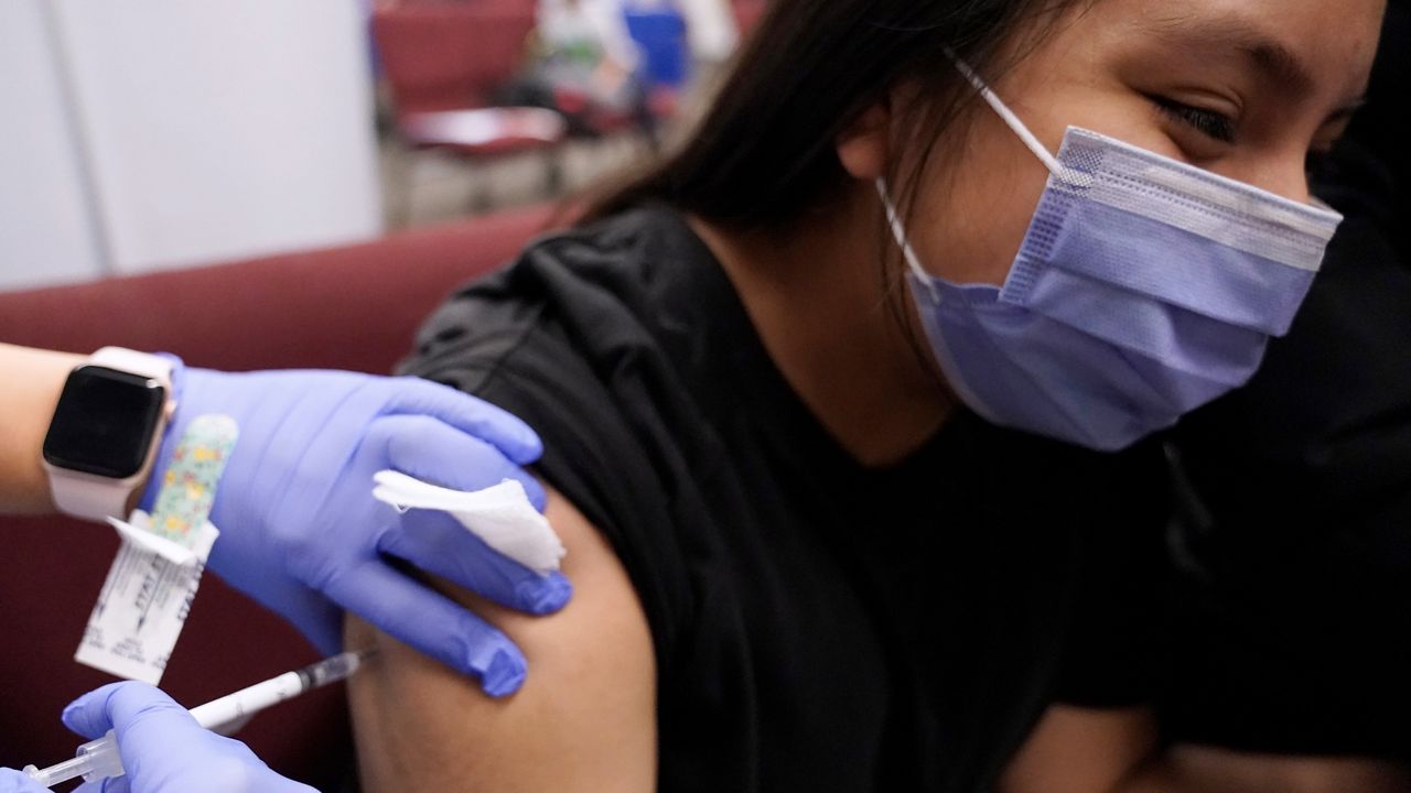 Doctors and public health officials give advice for staying safe from the coronavirus during the holiday: get vaccines and booster shots, wear a mask and get tested before traveling.