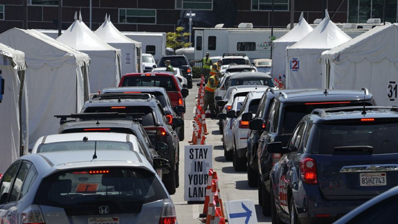 Motorists sit inside their vehicles as they wait their turn to be inoculated with a COVID-19 vaccine at the California State University, Los Angeles campus in Los Angeles, Thursday, April 8, 2021. (AP Photo/Damian Dovarganes)