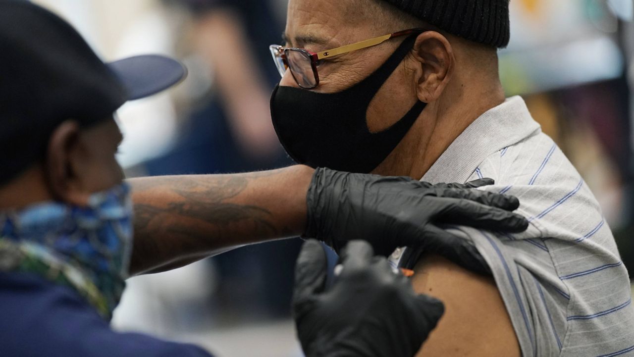 Wayne Pollard receives a COVID-19 vaccine in North Las Vegas, Nevada, on Wednesday. (AP Photo/John Locher)