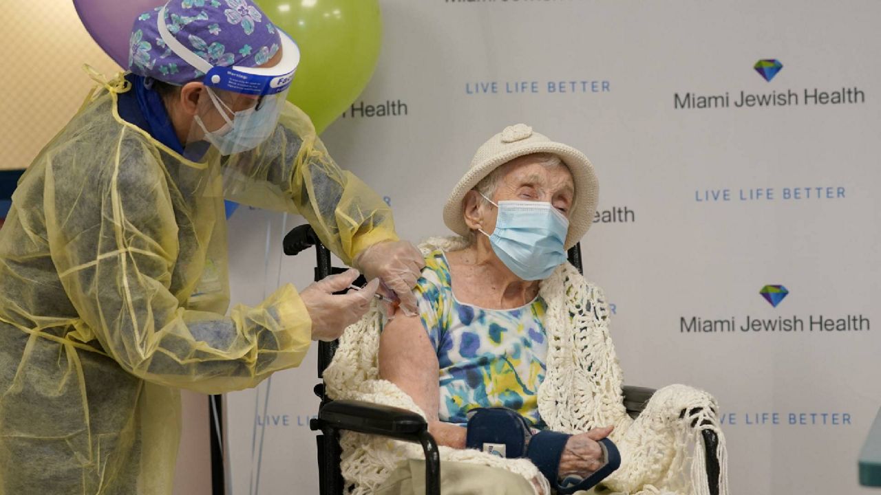 A nurse administers the Moderna COVID-19 vaccine to Luz Collazo, 103, at a senior healthcare facility in Miami Monday. (AP Photo/Lynne Sladky)