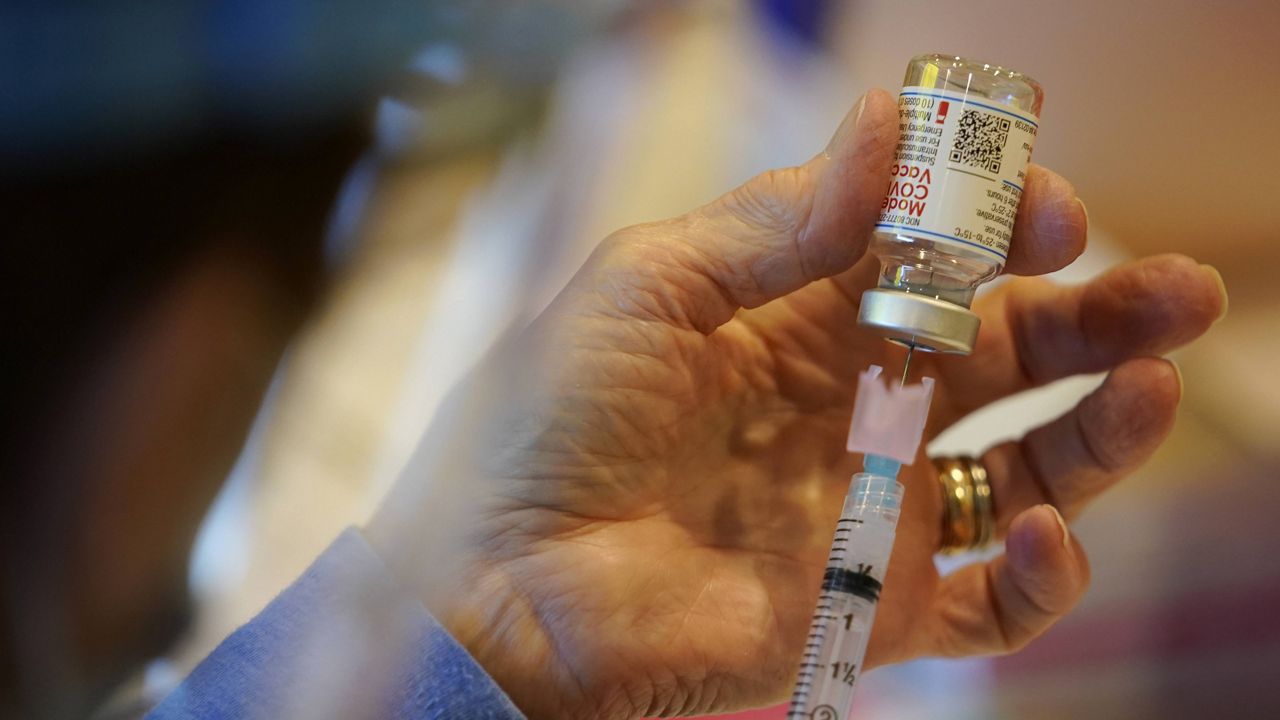 A health care worker fills a syringe with Moderna COVID-19 vaccine in West Chester, Pa. (AP Photo/Matt Slocum, File)
