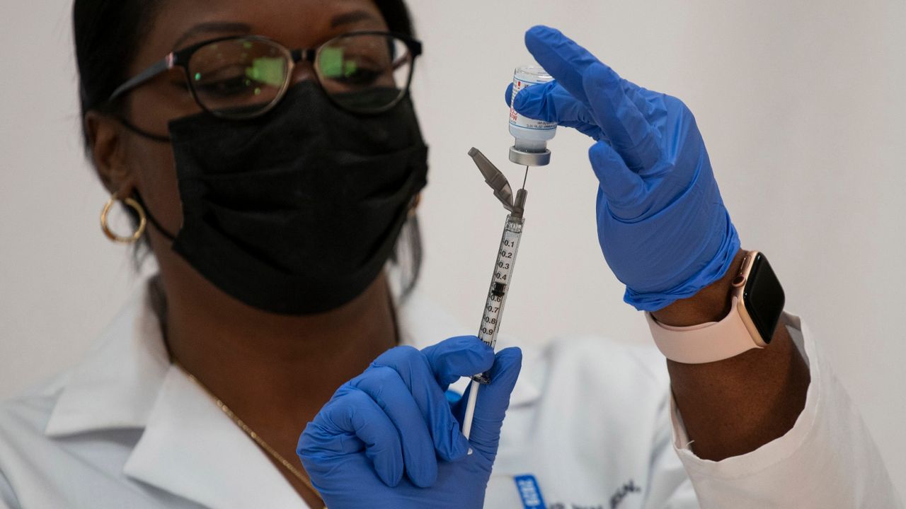 A medical professional works on a COVID-19 vaccine dose. (Spectrum News 1/File)