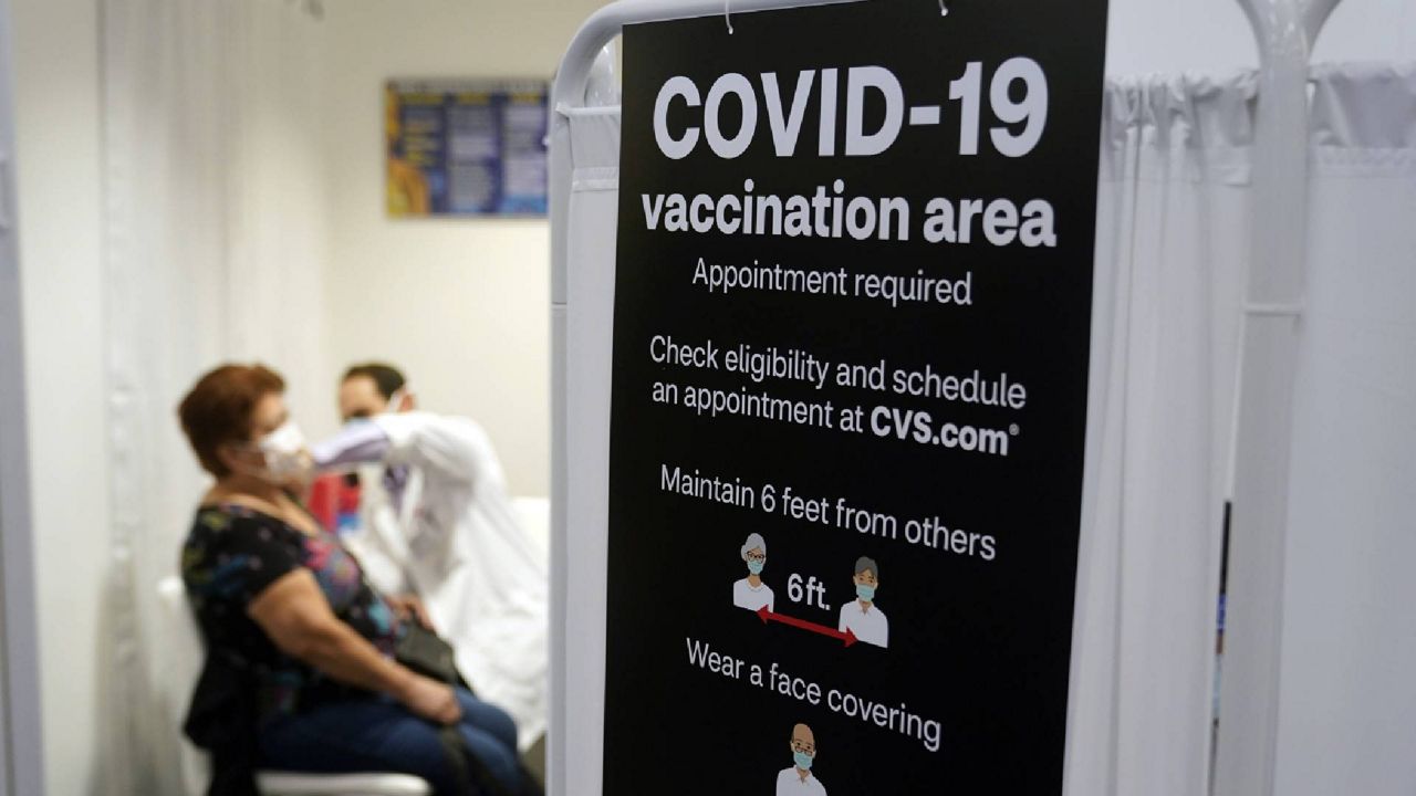 FILE - In this March 1, 2021, file photo, a patient receives a shot of the Moderna COVID-19 vaccine at a CVS Pharmacy branch in Los Angeles. (AP Photo/Marcio Jose Sanchez, File)