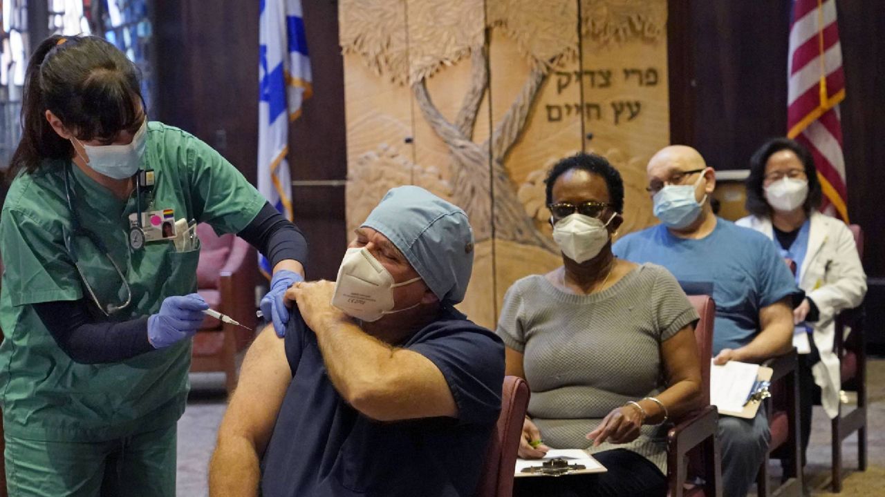 A nurse manager receives a COVID-19 vaccine at Hebrew Rehabilitation Center Wednesday in Boston. (AP Photo/Elise Amendola)