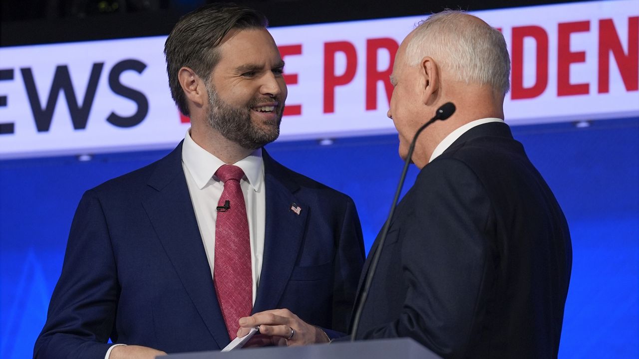 Republican vice presidential nominee Sen. JD Vance, R-Ohio, talks with Democratic vice presidential candidate Minnesota Gov. Tim Walz after the vice presidential debate hosted by CBS News Tuesday, Oct. 1, 2024, in New York. (AP Photo/Matt Rourke)