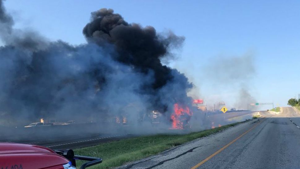 A tractor-trailer is in flames along Interstate 35 near New Braunfels, Texas, in this image from July 27, 2018. (New Braunfels Police Dept.)