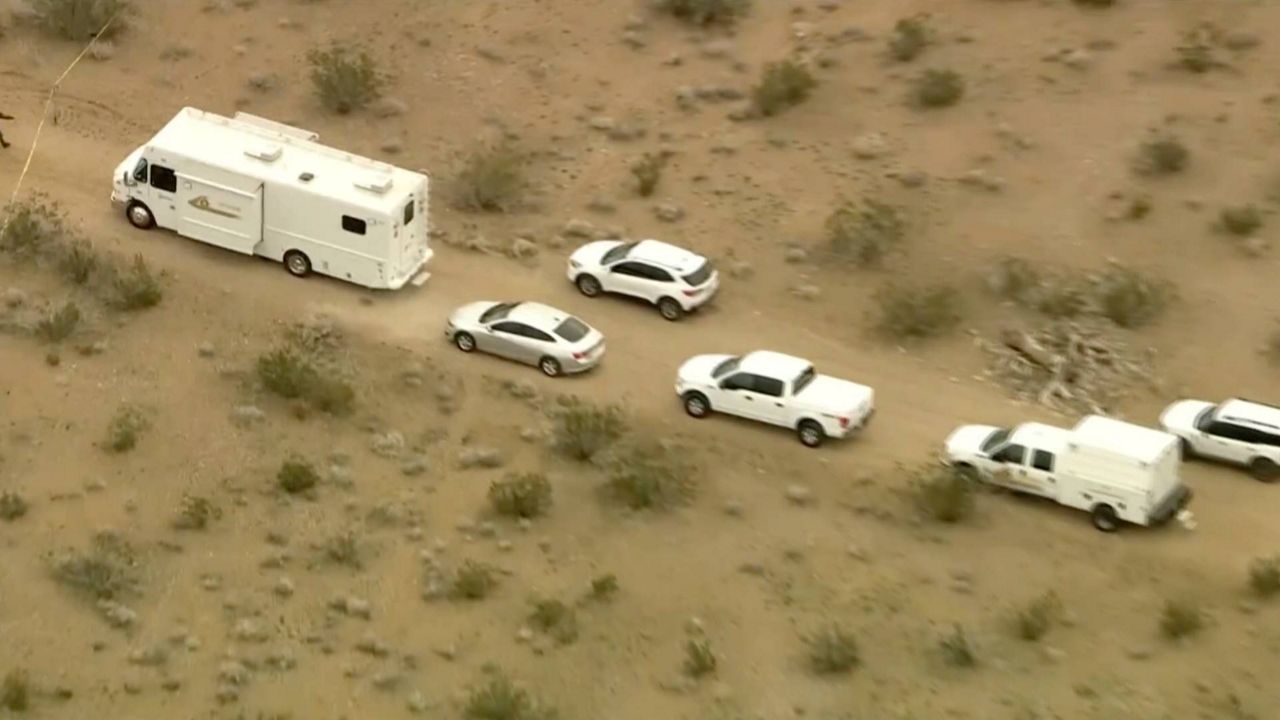 This aerial still image from video provided by KTLA shows law enforcement vehicles where several people were found shot to death in El Mirage, Calif., on Wednesday. (KTLA via AP)