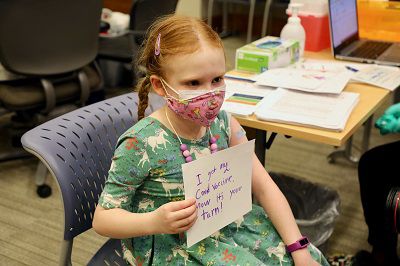 Verity, age 8, holds a sign after getting vaccinated. (Provided: Cincinnati Children's Hospital Medical Center)