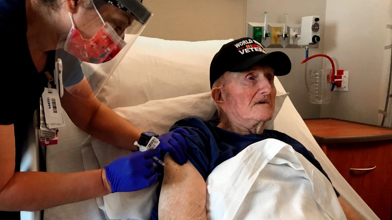 A nurse administers a COVID-19 vaccine to a veteran. (Associated Press)