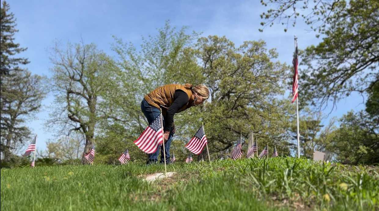 Donna Galik places flags on veterans' graves.