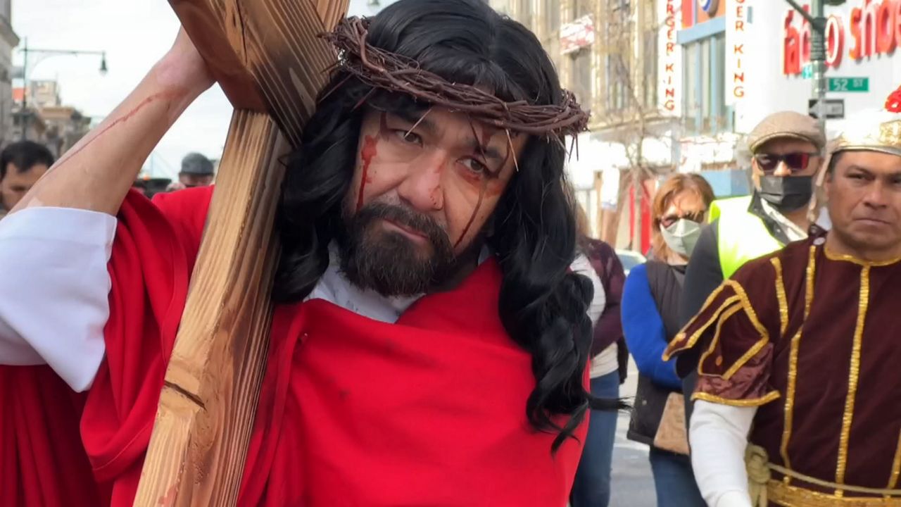 Faithful participate in procession of the Stations of the Cross in Sunset Park