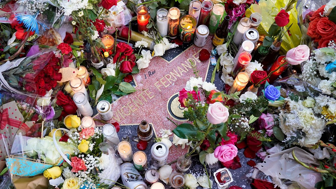 Flowers and candles surround the Hollywood Walk of Fame star of the late Mexican musician Vicente Fernandez, Monday, Dec. 13, 2021, in Los Angeles.