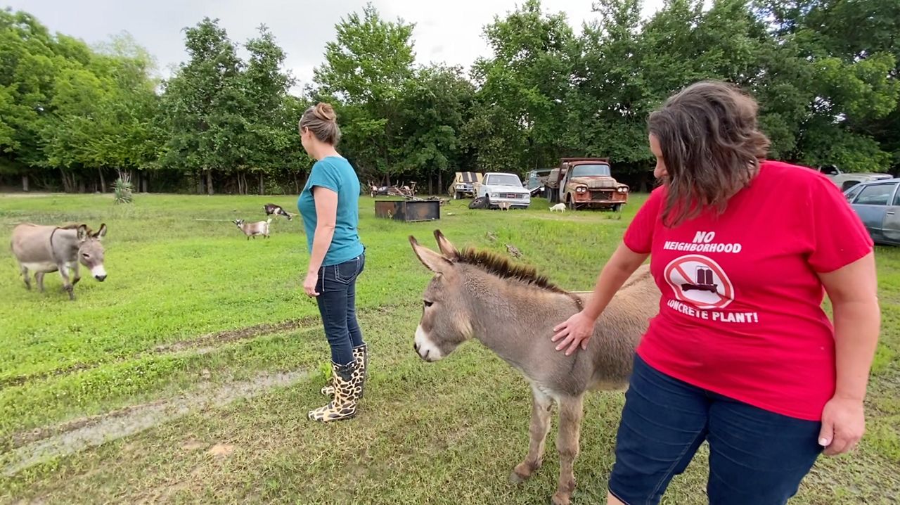 Vicki Polson and neighbor caring for animals across from the site where the plant would be located. (Spectrum News 1/Magaly Ayala)