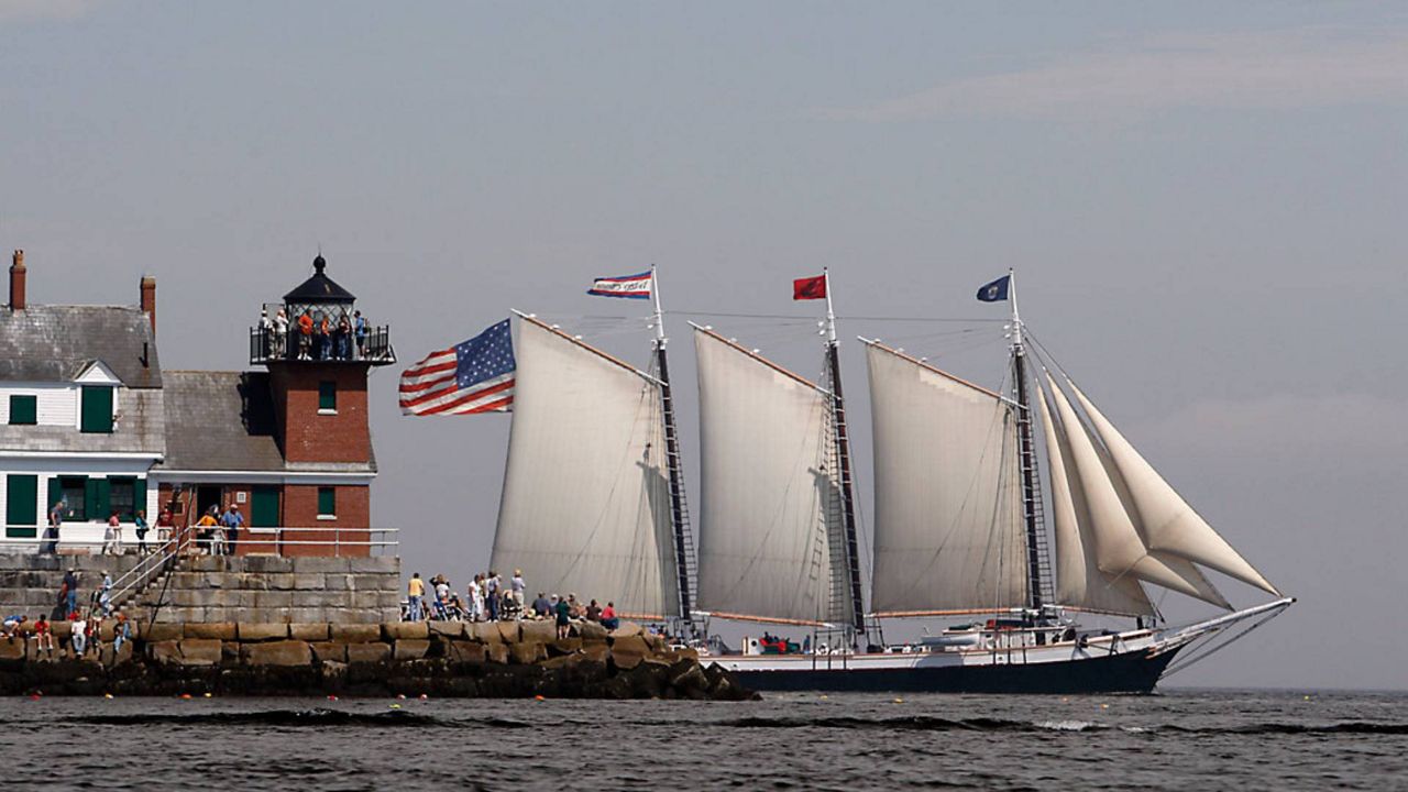 The Victory Chimes passes the Rockland Breakwater Lighthouse during the Maine Windjammer Parade in 2009, in Rockland. The three-masted schooner that’s on the National Register of Historic Places is up for sale. The Victory Chimes' owner announced 2022 will be the final season for the windjammer that’s so synonymous with Maine that the 2003 state quarter featured a sailing vessel modeled after the schooner. (AP Photo/Robert F. Bukaty, File)