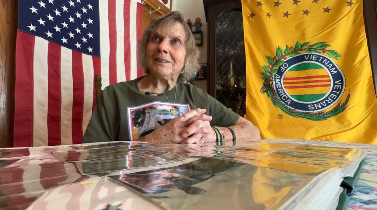 Ruby Scheuing looks at old pictures from the war.