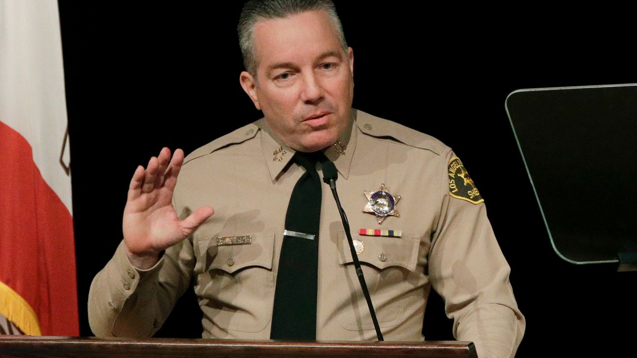 In this Dec. 3, 2018 file photo newly-elected Los Angeles County Sheriff Alex Villanueva speaks during a ceremony in Monterey Park, Calif. Los Angeles Superior Court Judge Mitchell Beckloff overturned Monday, Aug. 19, 2019, Villanueva's controversial rehiring of a deputy and ordered him to surrender his badge and weapon. (AP Photo/Jae C. Hong, File)