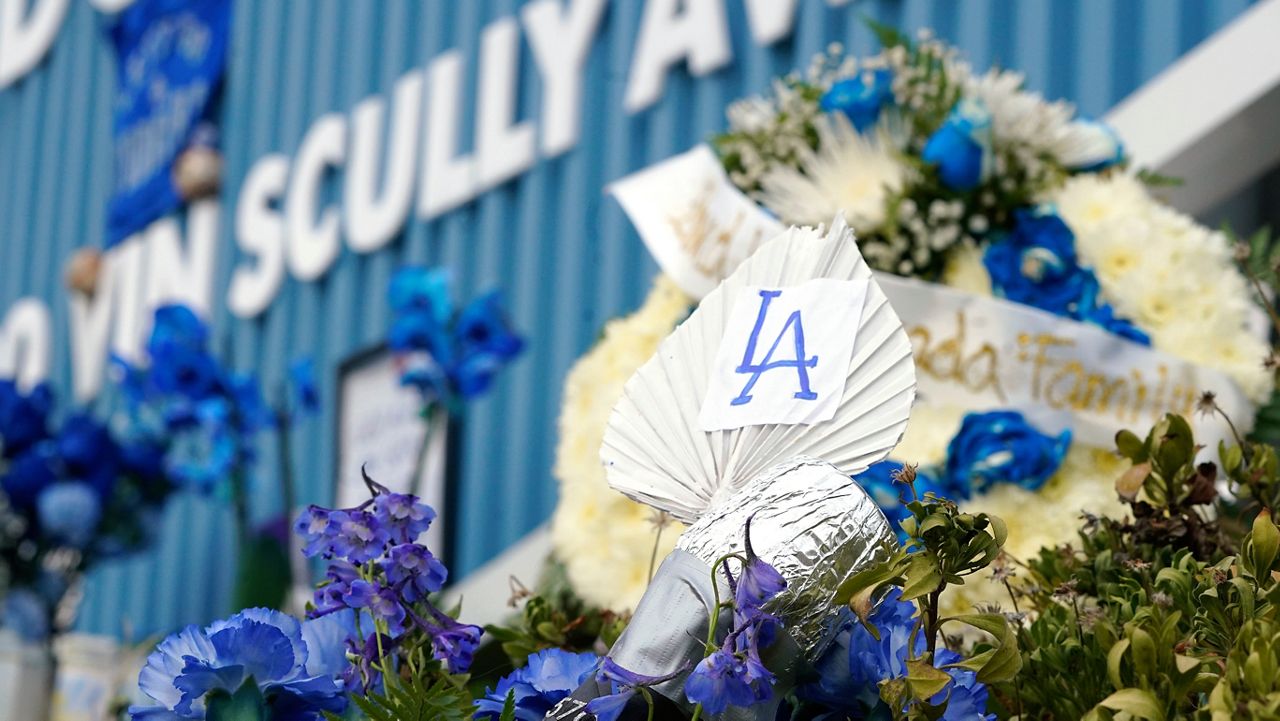 A homemade microphone and wreath is seen at a makeshift shrine in honor of broadcaster Vin Scully outside Dodger Stadium Thursday in Los Angeles. (AP Photo/Mark J. Terrill)